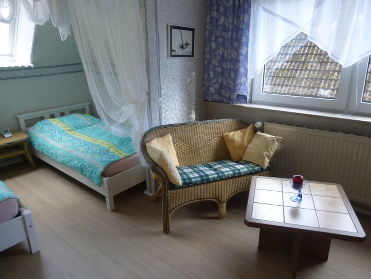 Schlafzimmer mit Sitzgelegenheit und 2 Betten